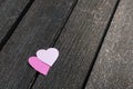 Love concept: Two paper hearts on a dark wood board Royalty Free Stock Photo