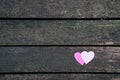 Love concept: Two paper hearts on a dark wood board Royalty Free Stock Photo