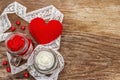 Love concept for Valentines day or mothers day. Red felt heart, glass jar, roses, ribbons. Old wooden boards background Royalty Free Stock Photo