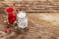 Love concept for Valentines day or mothers day. Red felt heart, glass jar, roses, ribbons. Old wooden boards background Royalty Free Stock Photo