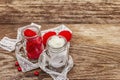 Love concept for Valentines day or mothers day. Red felt heart, glass jar, roses, ribbons. Old wooden boards background Royalty Free Stock Photo