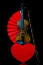 Love concept with violin, heart shape gift box and a red folding fan Royalty Free Stock Photo