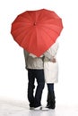 love couple standing together under red heart umbrella on white studio background