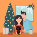 Love couple with black cat with bow. Happy family celebrating Christmas. Window with snow. Christmas tree, gift box presents, fir