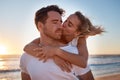 Love, couple and cheek kiss at beach on date, vacation or summer trip. Sunset, affection or romance of man and woman Royalty Free Stock Photo