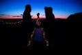 Love couple holding with teepee during dark sunset in quarry Hady Brno with view on city centre