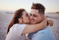 Love, couple and kiss on beach happy to celebrate relationship with sunset being relax, smile and on holiday. Romance Royalty Free Stock Photo