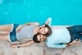 Love couple lying near swimming pool Royalty Free Stock Photo