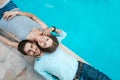 Love couple lying near swimming pool Royalty Free Stock Photo