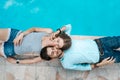 Love couple lying near swimming pool Royalty Free Stock Photo