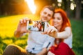 Love couple makes selfie in summer park on sunset Royalty Free Stock Photo