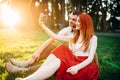Love couple makes selfie in summer park on sunset Royalty Free Stock Photo