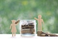 Love couple putting a coin into the glass bottle on green background, Finance, Saving for lover or family and save money for Royalty Free Stock Photo