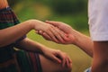 Hands of a young couple with a ring. close up of man giving diamond ring to woman Royalty Free Stock Photo