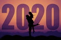 Love couple silhouette with big new year 2020 and sunset
