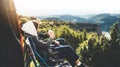 Love couple sit in camping chairs on top of sun flare mountain, travelers drink tea on cup enjoy nature, romantic look into distan Royalty Free Stock Photo