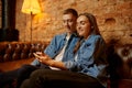 Love couple sitting on sofa in hookah bar Royalty Free Stock Photo