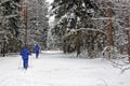 Love couple skiing in forest on a lovely winter day .