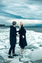 Love Couple stay on the ice floe, Thunder Sky and sea . melting glaciers