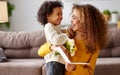 Young mixed race woman getting congratulations from son on Mothers day Royalty Free Stock Photo