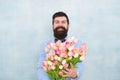 Love date with flowers. Happy Birthday. bride groom at wedding party. bearded man in bow tie with tulip flowers. spring Royalty Free Stock Photo