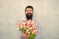 Love date with flowers. Happy Birthday. bride groom at wedding party. bearded man in bow tie with tulip flowers. spring Royalty Free Stock Photo