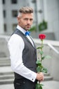 love day concept. handsome tuxedo man with love rose. flower gift for love day