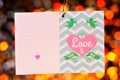 Love day frame Valentine greetings on bokeh background. Holiday frame text love greetings, colorful lights in the frame of hearts