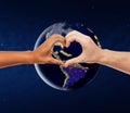 Hands showing heart gesture over earth in space Royalty Free Stock Photo