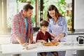 We love doing things as a family. a young family making pizza together. Royalty Free Stock Photo