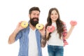 We love donuts. Fathers day present. Perfect for dads with sweet tooth. Girl child and dad hold colorful glazed donuts Royalty Free Stock Photo