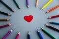 Love of drawing: a circle of colored pencils, in the center of the circle is a  heart Royalty Free Stock Photo