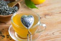 Love drinking tea with infuser heart valentines abstract concept on wooden background
