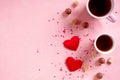 Love drinks. Coffee tea cups, sweets candy chocolate on pink hearts background. Valentines day 14 february minimal Royalty Free Stock Photo