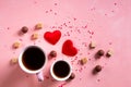 Love drinks. Coffee tea cups for two, sweets candy chocolate on pink hearts background. Valentines day 14 february Royalty Free Stock Photo