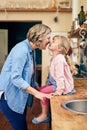 They love each other with all of their hearts. a cheerful young mother touching noses with her young little daughter in Royalty Free Stock Photo