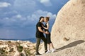 In love Eastern couple in mountains of Cappadocia hugs and kisses. Love and emotions loving couple vacationing in Turkey. Closeup