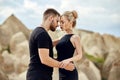 In love Eastern couple in mountains of Cappadocia hugs and kisses. Love and emotions loving couple vacationing in Turkey. Closeup