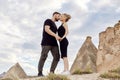 In love Eastern couple in mountains of Cappadocia hugs and kisses. Love and emotions loving couple vacationing in Turkey. Closeup