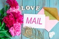 Love email background. Blue color wooden background with flowers peonies, envelopes. Flat lay, top view. Royalty Free Stock Photo
