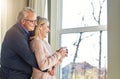 They love enjoying their home together. an affectionate senior married couple spending time together at home. Royalty Free Stock Photo