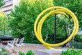 Love Exists by John Clement. Spiral stell yellow sculpture Omaha Nebraska.