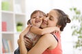 Love and family people concept - happy mother and child daughter hugging at home Royalty Free Stock Photo