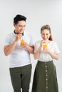 Love, family, healthy food and happiness concept - smiling happy couple drinking juice on white background Royalty Free Stock Photo