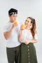 Love, family, healthy food and happiness concept - smiling happy couple drinking juice on white background Royalty Free Stock Photo