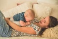 Love and family. Home portrait of a baby boy with mother on the bed. Mom play and kissing her child Royalty Free Stock Photo