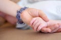 Love, family and mother holding hands with her baby in the home for trust, care or bonding together closeup. Children Royalty Free Stock Photo