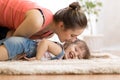 Love and family people concept - happy mom and child daughter having a fun at home Royalty Free Stock Photo