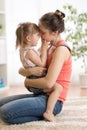 Love and family people concept - happy mother and child daughter hugging at home Royalty Free Stock Photo