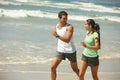 For the love of fitness. a young couple jogging together on the beach. Royalty Free Stock Photo